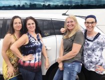 4 smiling women in front of a stretch